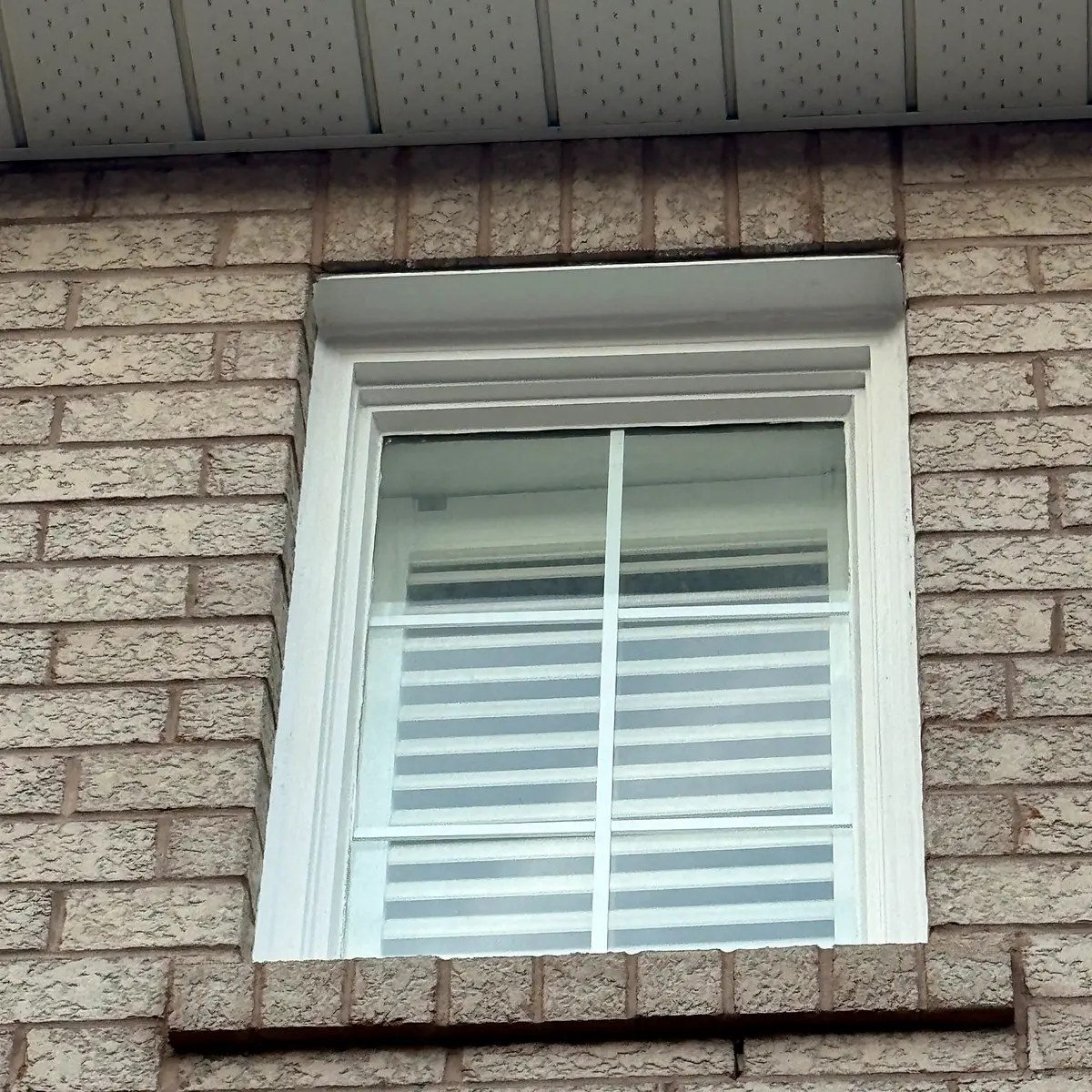 Real completed exterior window frame and white trim restoration